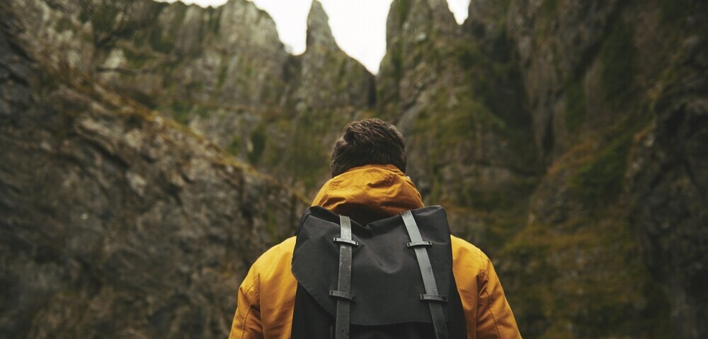 Man looking to hiking a mountain